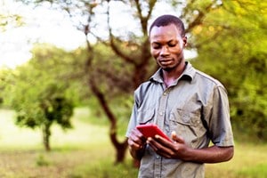 african man outside on cell phone