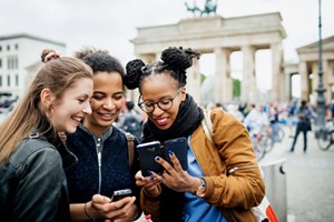 group in europe looking at cell phones in outdoor
