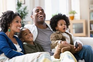 african household enjoying tv program