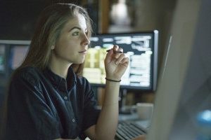 woman contmplating in front of computer screen