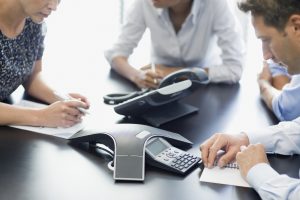 group around polycom phones listening to call