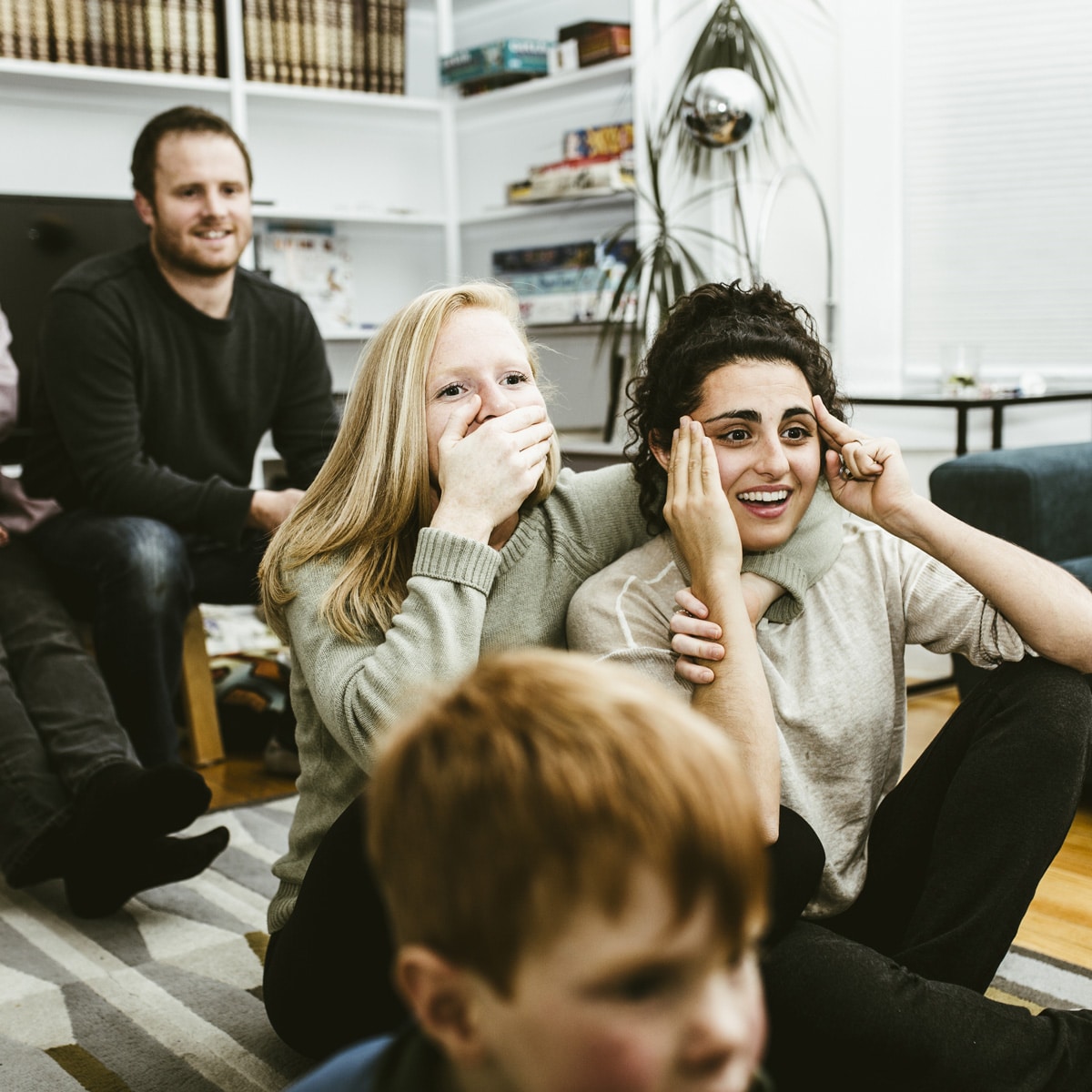 family watching exciting game on television