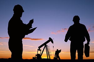 man working on tablet at remote oil rig site