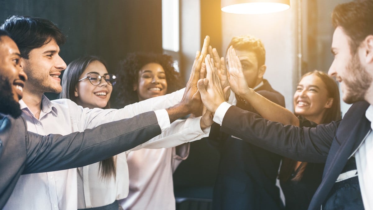 diverse group of employees high fiving