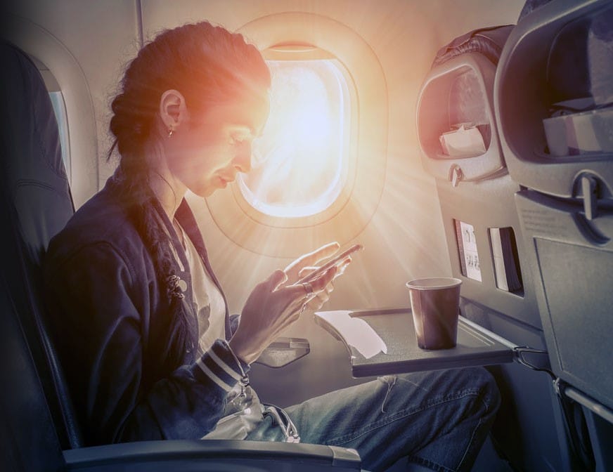 woman on plane on cell phone