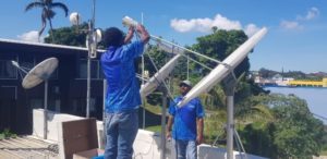 Workers restoring communications on the island of Vanuatu in the Solomon Islands.