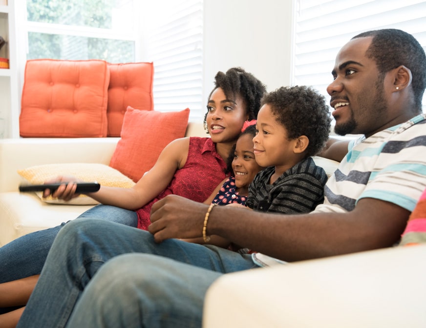 african family watching tv