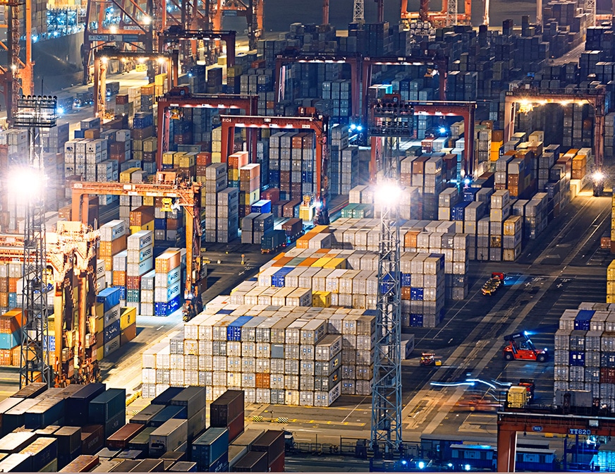 cargo ship being loaded at night time