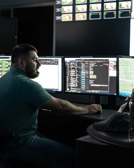 Man on computer working on advanced communication technology for global connectivity solutions.