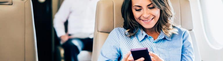 a woman sitting in a chair looking at her phone