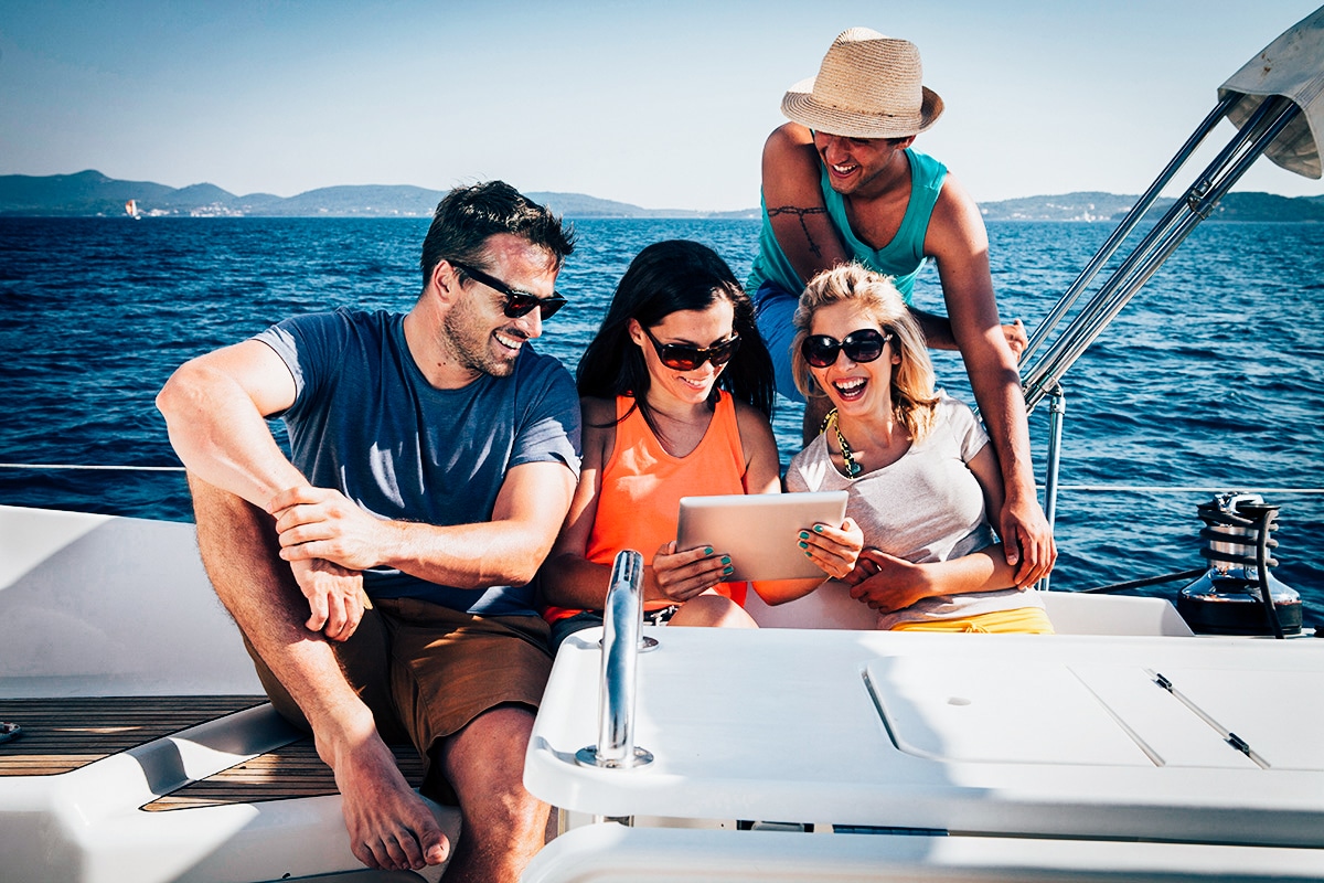 group on yacht with tablet