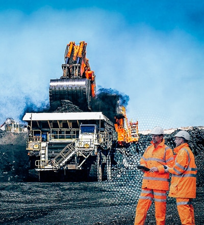 workers in front of earth mover