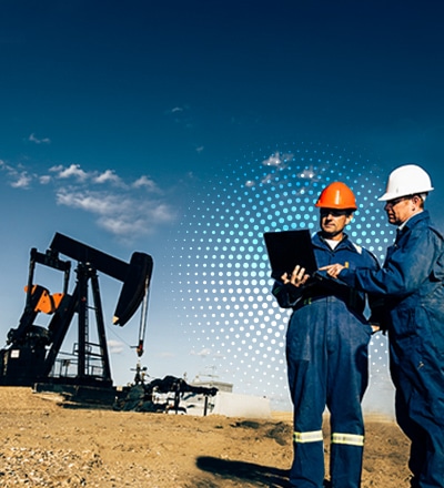 workers in front of oil pump