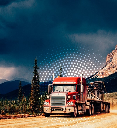 semi-truck pulling flatbed with load