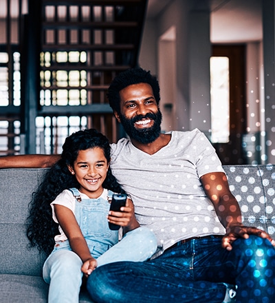 man and girl on sofa
