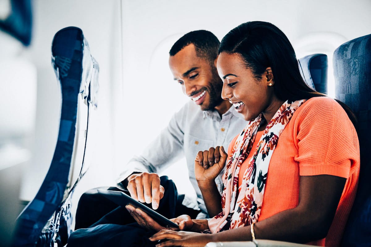 couple using tablet inflight