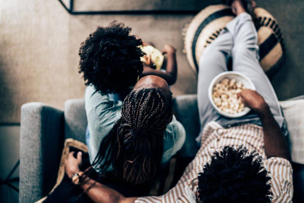 family watching tv popcorn