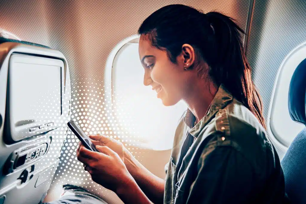 airplane passenger using IFC on phone