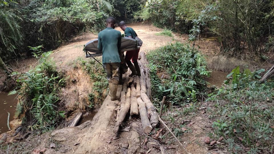 workers carry satellite equipment to bridge the digital divide in Congo